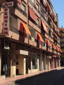a building with a sign on the side of a street at PENSIÓN ROSA in Benidorm