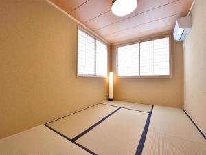 an empty room with a light and a window at ShukuShuku in Kyoto