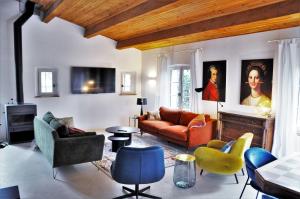 a living room with a couch and chairs at Un je ne sais quoi de Paradis in Les Vans