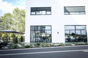 a white building with windows on the side of a street at Prime Park Penthouse Aschaffenburg in Aschaffenburg