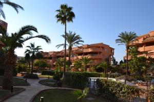 a view of a resort with palm trees and buildings at Apartementos Almerimar Golf in Almerimar