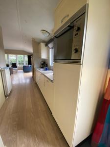 a kitchen with a refrigerator and a counter top at Chalet Togo in Wageningen