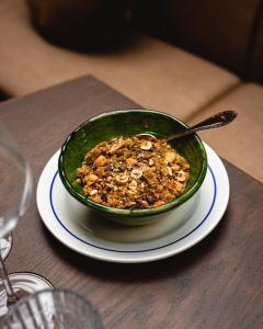 a bowl of food is sitting on a wooden table at Babel Belleville in Paris
