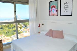 a bedroom with a white bed and a large window at Bungalow con vistas panorámicas a Calpe - Inmodream Calpe in Calpe +28 photos