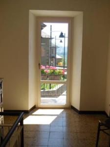 an empty room with an open door with a window at Le Camere della Piazza in Rigoso