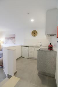 a kitchen with white cabinets and a counter top at Bayside Salgados in Albufeira