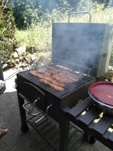 a grill with a bunch of hot dogs on it at Ferienwohnung Pietzavka in Wiesenfelden