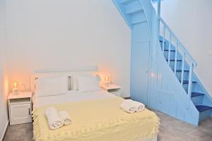 a bedroom with a bed and a blue staircase at cherry's home in Glossa