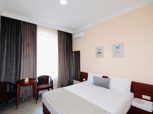 Voodi või voodid majutusasutuse Grand Fortune Hotel toas