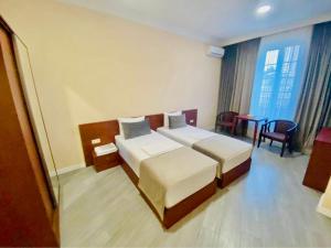 Voodi või voodid majutusasutuse Grand Fortune Hotel toas