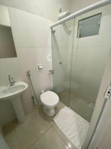 y baño con ducha, aseo y lavamanos. en Pousada Dona Lia, en Uberlândia