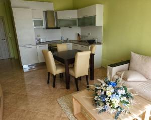 uma sala de estar com uma mesa e cadeiras e um sofá em Elegantz Apartments LaMer em Varna City