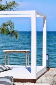 a white picnic table in front of the ocean at Sanae Beach Hua Hin in Khao Tao