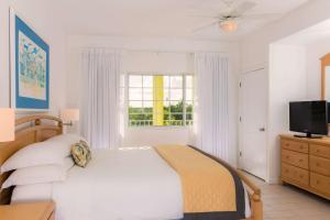 
A bed or beds in a room at Wyndham Reef Resort, Grand Cayman
