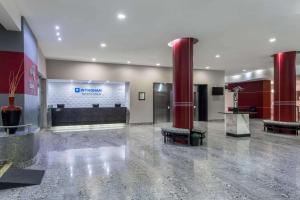 a lobby with a reception desk in a building at Wyndham Executivo Culiacan in Culiacán