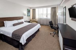 a hotel room with a bed and a flat screen tv at Wyndham Executivo Culiacan in Culiacán +93 photos