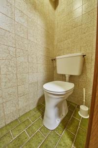 a bathroom with a white toilet in a tiled room at Appartement Slope & Smile in Saalbach-Hinterglemm