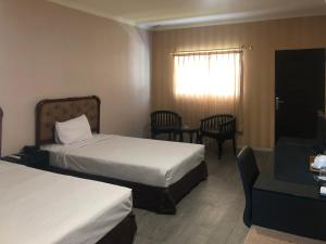 Postel nebo postele na pokoji v ubytování Hotel Sinar 3