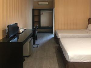 Postel nebo postele na pokoji v ubytování Hotel Sinar 3