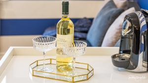 a bottle of wine and two wine glasses on a table at Apartament 117 HVILE in Gdańsk
