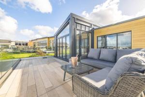 a living room with a couch and a table at LUXURY LODGE - STUNNING RIVER VIEWS & HOT TUB in Dorney