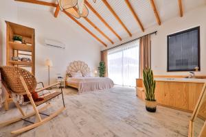 a bedroom with a bed and a large window at Golden Lighthouse Hotel in Patara