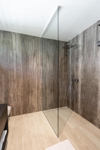 a bathroom with a shower with a glass wall at Maison du Soleil in Kranjska Gora
