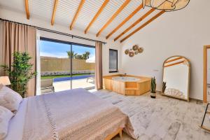 a bedroom with a bed and a tub and a mirror at Golden Lighthouse Hotel in Patara