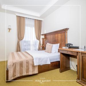 Postel nebo postele na pokoji v ubytování Hotel Garden