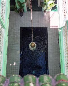 an overhead view of a bathroom with a ball in the water at Riad Dar Rabiaa in Rabat