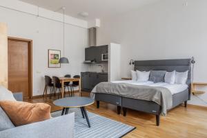 a bedroom with a bed and a living room at The More Hotel Mazetti in Malmö +79 photos