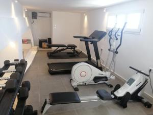 a gym with several exercise equipment in a room at Santorini Secret Suites & Spa, Small Luxury Hotels of the World in Oia