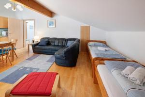 a living room with two beds and a couch at Haus Lowe Appartement 2 Stock Nr 4 in Filzmoos