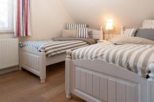 Ένα ή περισσότερα κρεβάτια σε δωμάτιο στο Ferien-im-Duenenhaus-Ole