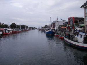 a group of boats are docked in a canal at Pension Arielle _ Objekt 28014 in Warnemünde