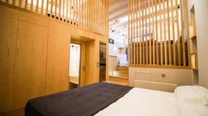 een slaapkamer met een groot bed en houten wanden bij The One Arachova in Arachova