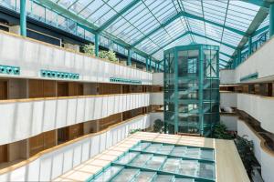 an image of a building with a glass ceiling at Exe Gran Hotel Almenar in Las Rozas de Madrid