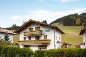 a large white building with wooden balconies on it at Haus Lowe Appartement 1 Stock Nr 2 in Filzmoos