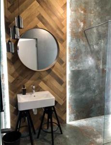 a bathroom with a sink and a mirror at Icon Apartaments Drobnera studio in Wrocław