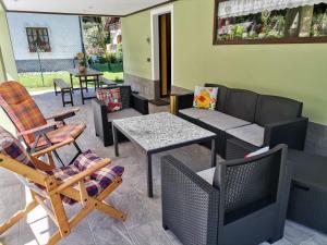 a patio with a couch and chairs and a table at ManuEbbasta in Scopello