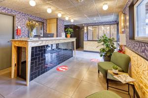 a lobby with a bar and a table and chairs at Eklo Hotels Le Havre in Le Havre