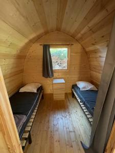 two beds in a small room with a window at Camping Les Maraises in Saint-Martin-de-Ré +64 photos