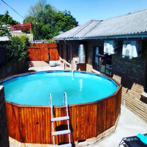 a large swimming pool with a ladder next to a house at The Green Olive Guesthouse in Bethlehem