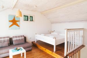 a bedroom with a bed and a couch at Barba Zoran in Bol