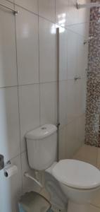 a white bathroom with a toilet and a shower at Pousada e Restaurante Império do Marisco in Maragogi +118 photos