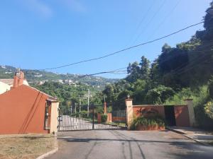a gate to a house with a fence at Oasis Realm in Kingston