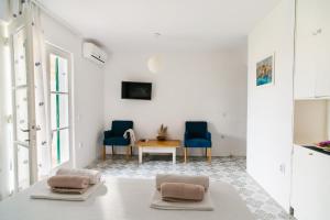 a living room with two blue chairs and a table at Barba Zoran in Bol