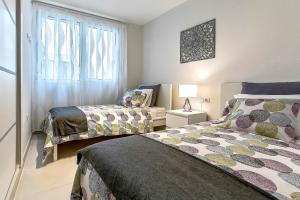 a bedroom with two beds and a window at Hortensia Suites Apartments, Los Cristianos, Tenerife in Los Cristianos