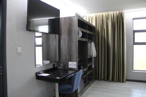 a room with a black desk and a cabinet at Urban Bliss Hotel in Kabwe
