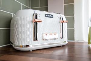 a toaster sitting on top of a wooden floor at Carnarvon House - Wi-Fi & Parking Contractors in Preston